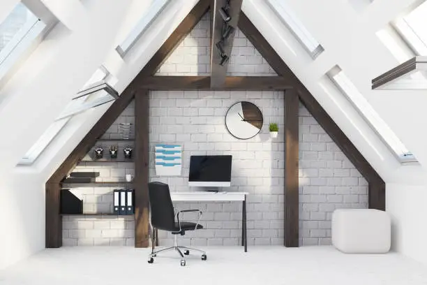 Attic workspace with sloped ceilings, built-in desk, and ergonomic chair – attic home remodeling