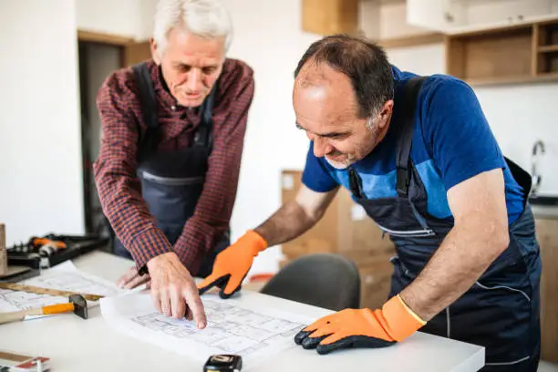 Bathroom remodel contractors reviewing universal design plans, showcasing KBR’s expertise in accessible kitchen and bathroom remodeling.