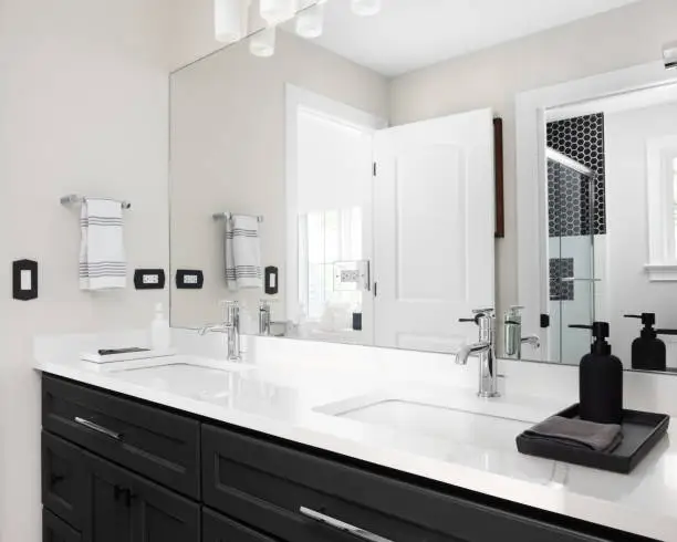 Bathroom renovation near me with double vanity and smart fixtures for daily self-care by KBR Kitchen & Bath.