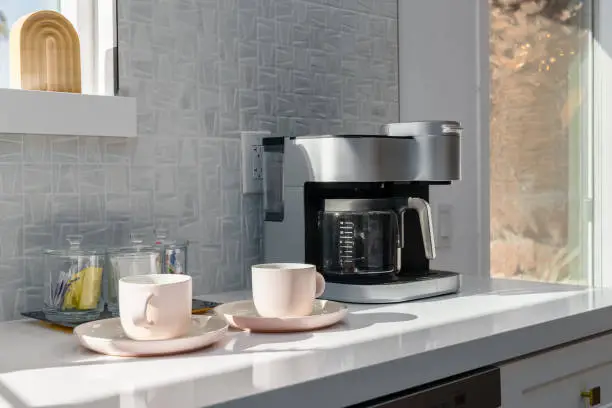 Sleek kitchen coffee station with quartz countertops, highlighting KBR’s kitchen and bathroom remodeling for efficient WFH setups.