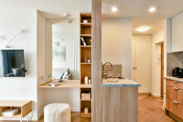 Multipurpose small bathroom remodel and kitchen island desk, optimizing space for remote work by KBR Kitchen & Bath.