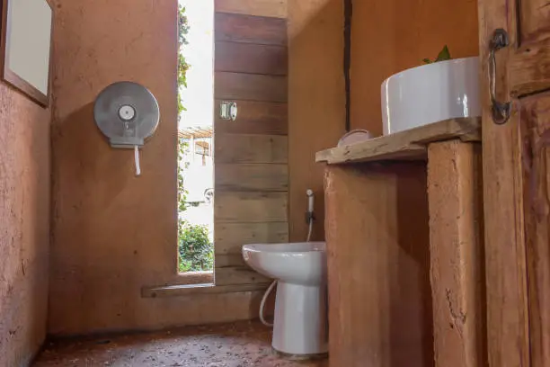 Bathroom with composting toilet and rainwater system, designed for off-grid resilience.