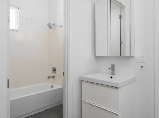 Bathroom with low-flow fixtures and insulated cabinetry.