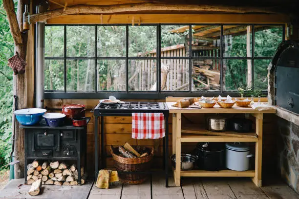 Off-grid kitchen with solar fridge, propane stove, and fire-resistant counters, showcasing KBR’s design.
