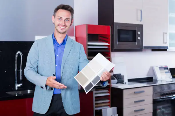Contractor presenting a Class A license and project portfolio in a showroom.