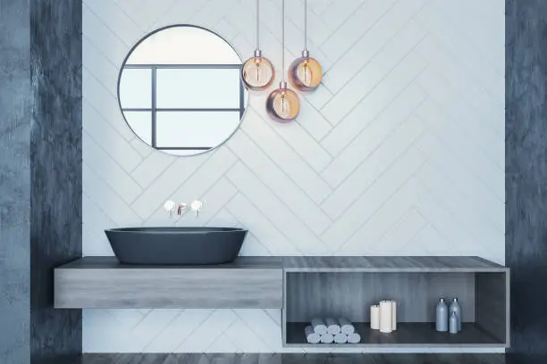 Modern bathroom with designer faucet and pendant lighting.