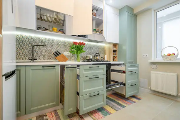 Kitchen with painted cabinets and smart storage solutions.