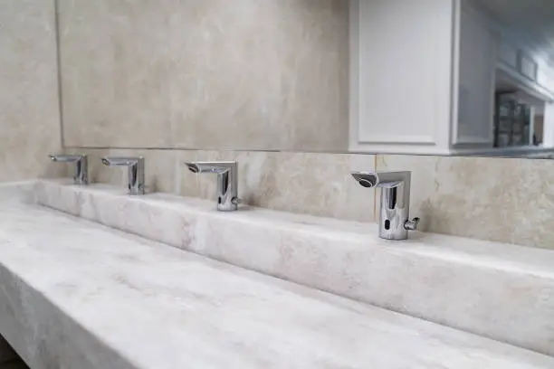Bathroom with touchless faucets and low-VOC tiles.