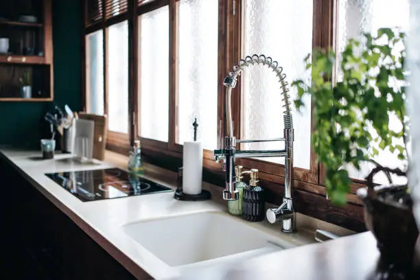 Kitchen with recycled glass countertops and vintage faucets.