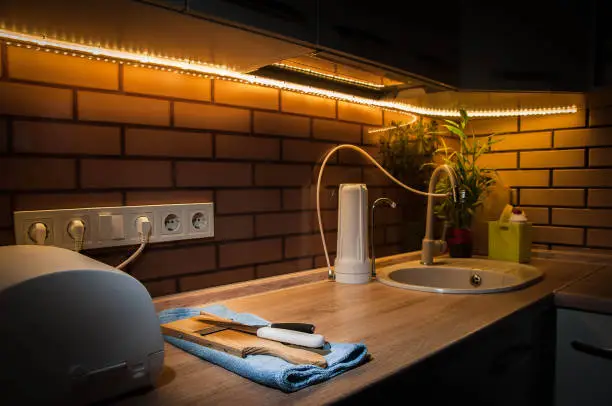Kitchen with under-cabinet LEDs and motion sensor lights.