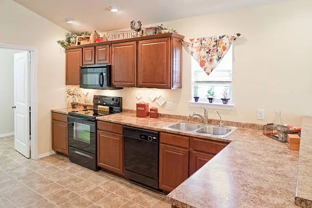 Kitchen with fire-resistant granite counters and mold-resistant vinyl flooring.