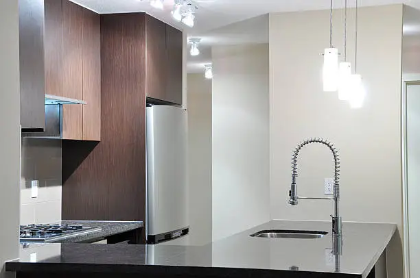 Small kitchen with ENERGY STAR fridge and low-flow faucet.