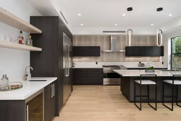 Kitchen with sleek grab bars and high-contrast cabinetry.