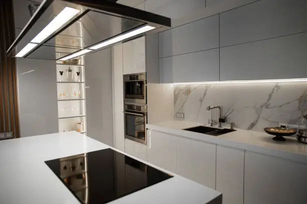 Kitchen with smart appliances and high-end lighting.