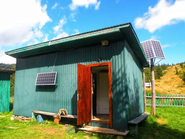 Off-grid bathroom with solar-powered lighting and greywater system.