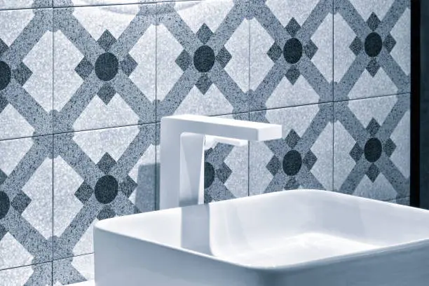 Bathroom with 3D-printed faucet and water-resistant tiles.