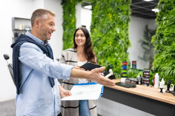 Contractor discussing wellness-focused kitchen plans in showroom.