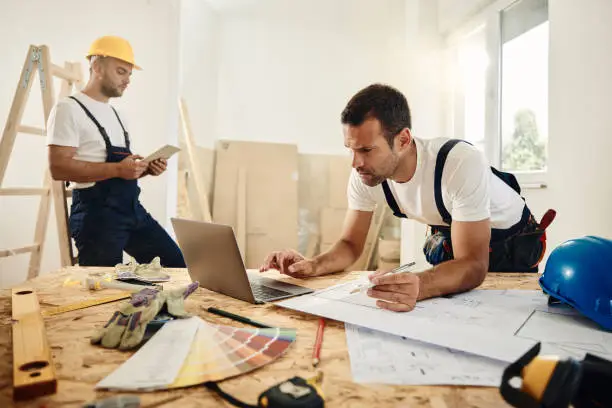 Professional kitchen remodel with a contractor reviewing a detailed contract, showcasing KBR’s trusted process.