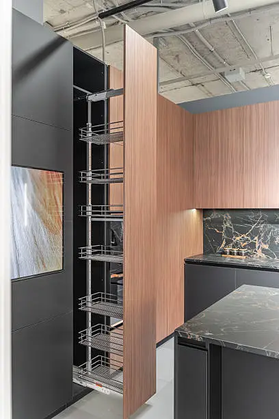 Kitchen with vertical racks and slim cabinets for storage.