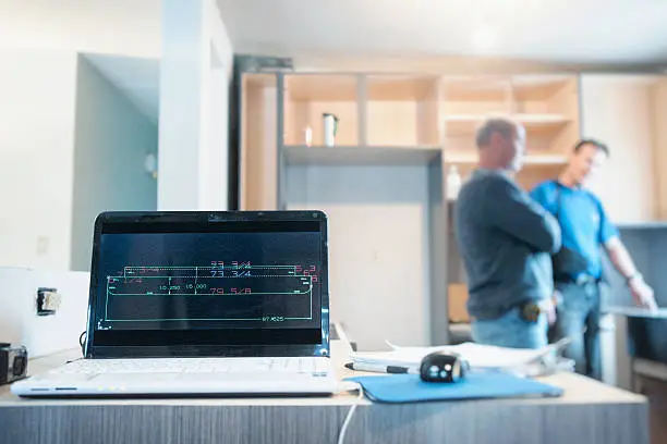 Kitchen remodel in progress with a clear timeline chart displayed on-site.