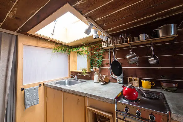 Kitchen with a high-altitude gas range and skylight for natural light.