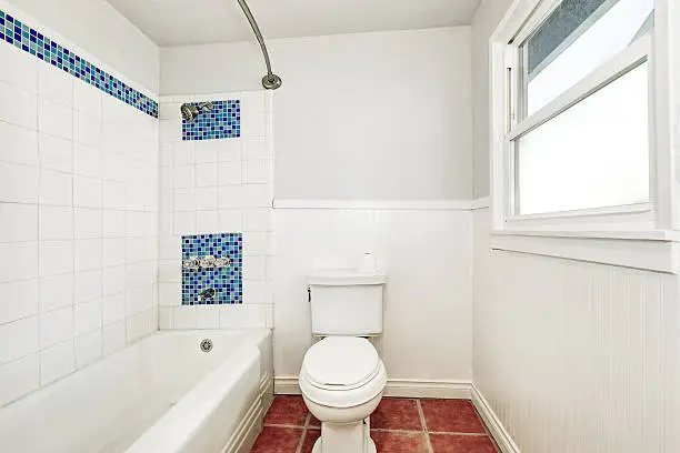 Bathroom with tile accents and new fixtures on a budget.