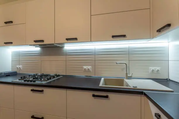Kitchen with affordable backsplash and LED lighting