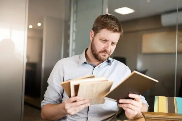 Contractor reviewing reclaimed wood samples in a showroom.
