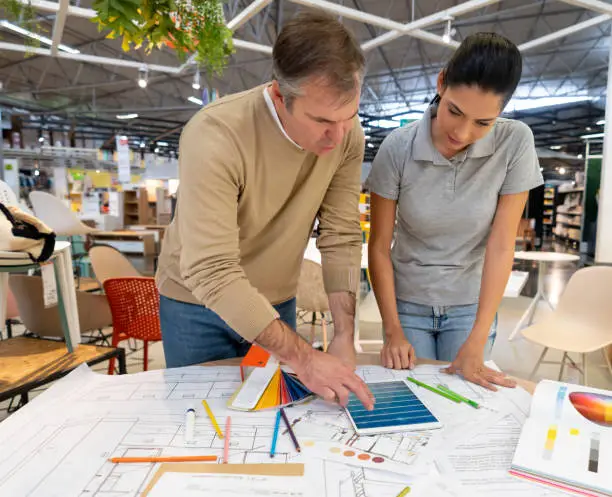 KBR contractor discussing seasonal remodel plans in a showroom