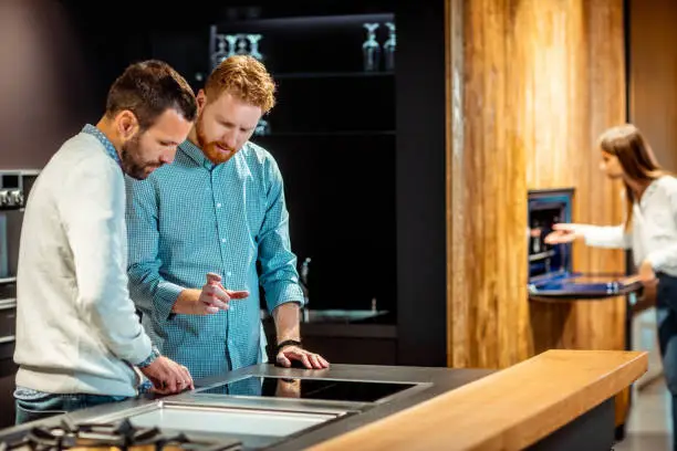 Contractor discussing smart tech integration in a showroom.