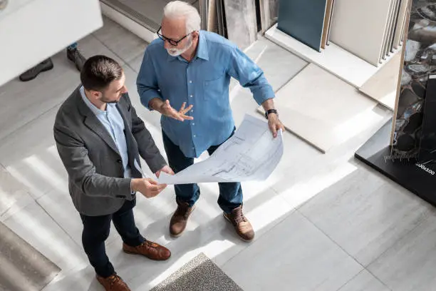 KBR contractor discussing dual remodel plans in a showroom