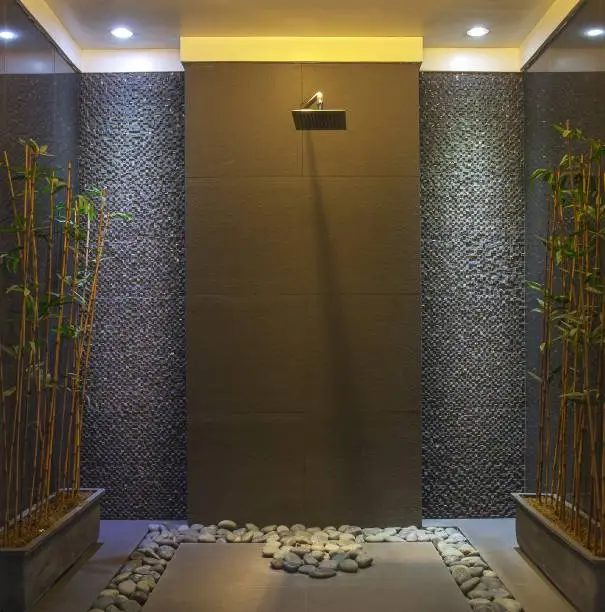 Bathroom with dimmable LEDs, and pebble tiles.