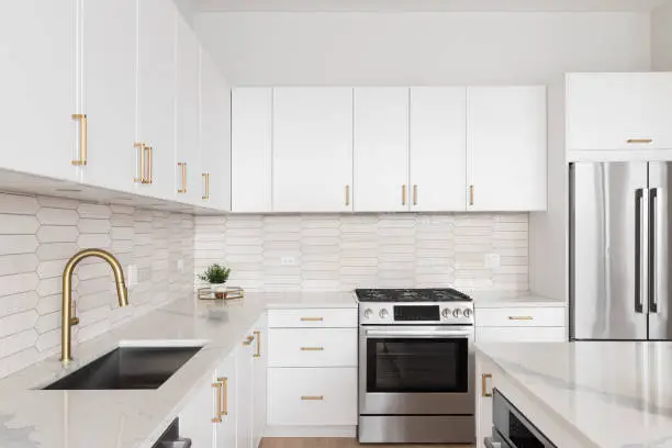 Kitchen with custom cabinetry and quartz countertops