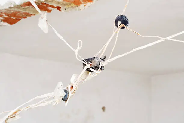 Home with exposed wiring and plumbing during a remodel inspection