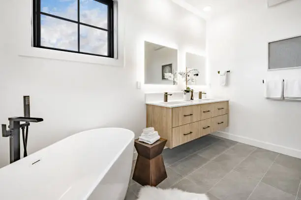 Bathroom with freestanding tub and sleek vanity finishes