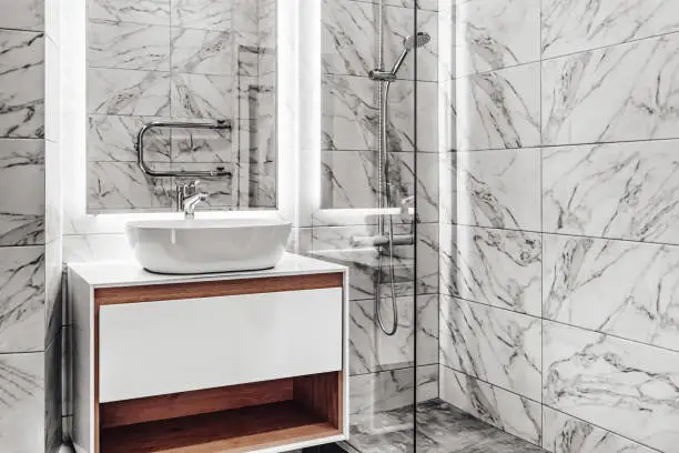 Bathroom with ceramic tiles mimicking marble and modern fixtures
