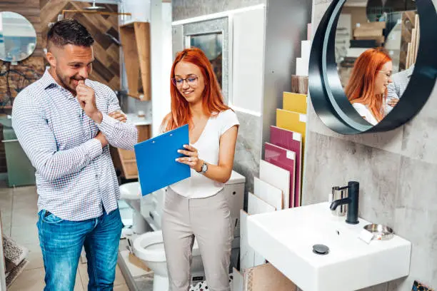 KBR contractor discussing small bathroom design in a showroom