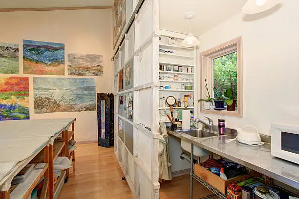 Kitchen with repurposed metal countertops and reclaimed wood shelving.