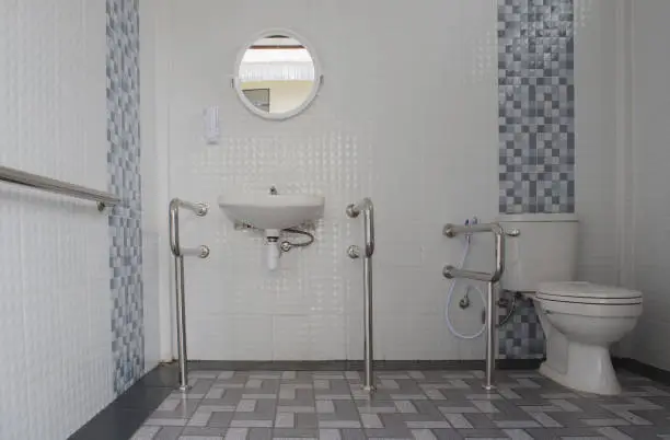 Bathroom with sealed tiles and elevated fixtures for flood protection.