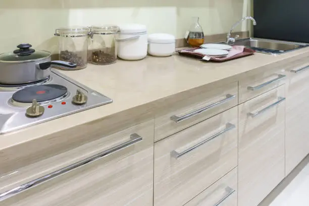 Kitchen with laminate countertops mimicking quartz and modern hardware