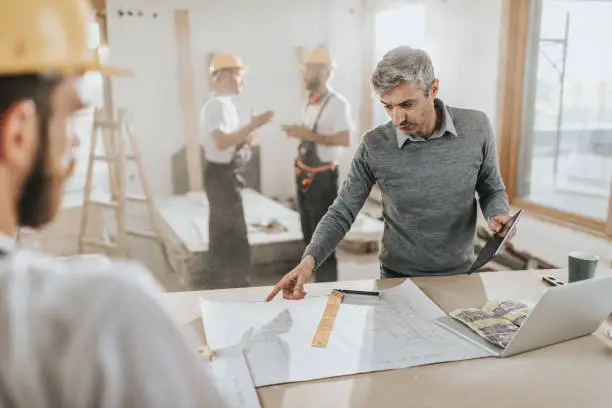 KBR contractor reviewing multigenerational remodel plans in a showroom