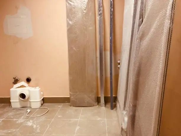 Bathroom with fast-curing tiles and temporary shower setup