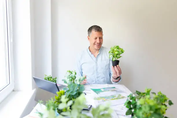 KBR designer reviewing herb garden plans in a showroom