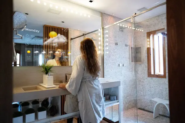 Bathroom with smart mirrors and voice-controlled showers