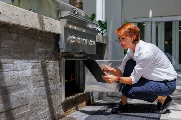 KBR contractor reviewing outdoor kitchen plans in a showroom