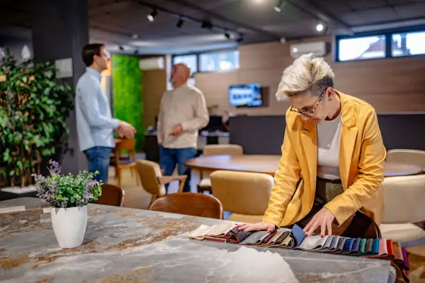 KBR contractor reviewing eco-friendly material plans in a showroom