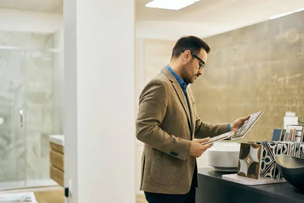 KBR contractor reviewing bathroom design in a showroom