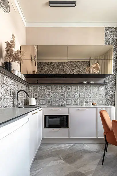 Kitchen with statement backsplash and smart appliances.