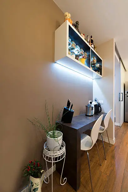 Small kitchen with multifunctional island and LED lighting