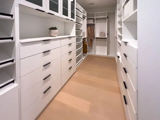 Closet with matte black hardware and floating shelves
